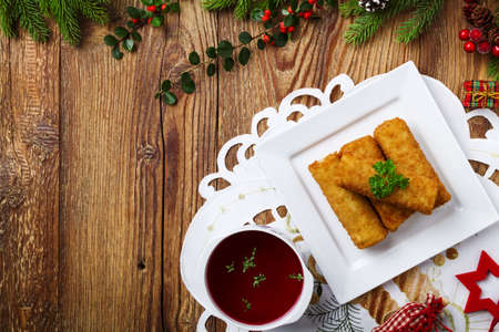Croquettes with sauerkraut and mushrooms served with beetroot soup. Christmas decoration.の写真素材