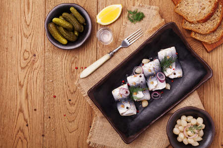 Rolled herring in vinegar, served with onions and pickles. Perfect for vodka.の写真素材