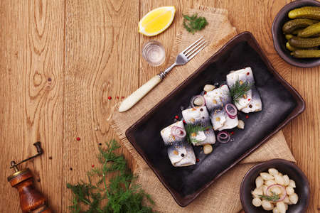 Rolled herring in vinegar, served with onions and pickles. Perfect for vodka.