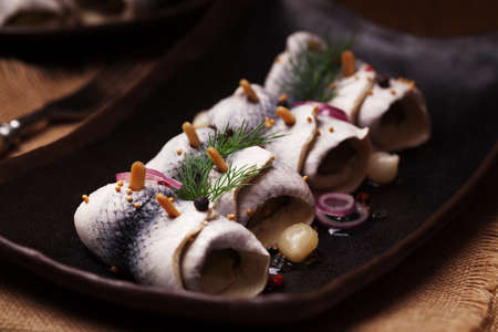 Rolled herring in vinegar, served with onions and pickles. Perfect for vodka.