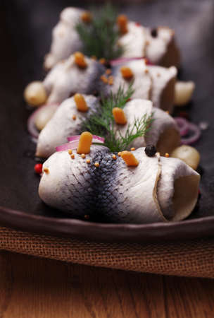 Rolled herring in vinegar, served with onions and pickles. Perfect for vodka.