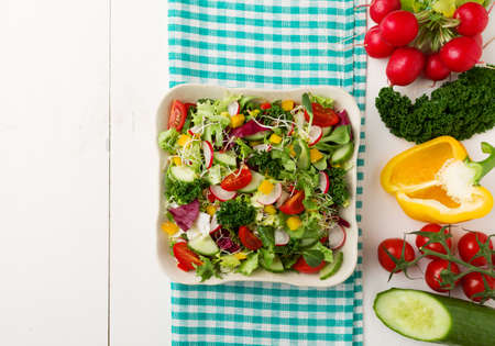Spring salad with fresh vegetables from radishes and kaleの写真素材