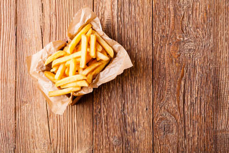 Fresh fried french fries on wooden backgroundの写真素材