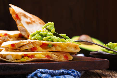 Quesadilla with chicken, served with guacamole or salsa sauce.の写真素材