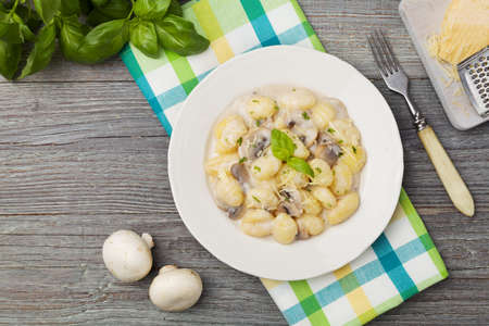 Portion of gnocchi with mushroom sauce and cheese.の写真素材