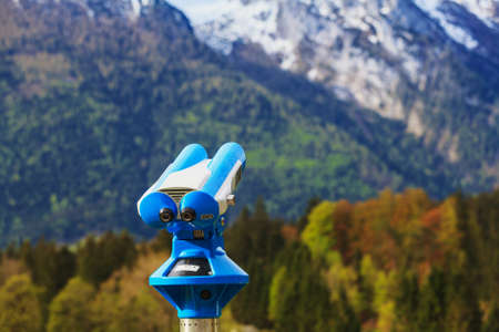 Telescope to observe landscapes available to tourists after paying. A view of the Alpine peak.の写真素材