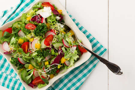 Spring salad with fresh vegetables from radishes and kaleの写真素材