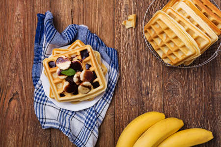 Delicious waffles with banana and chocolateの写真素材