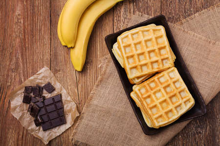 Delicious waffles with banana and chocolateの写真素材
