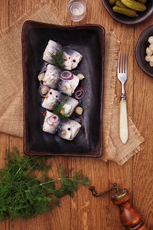 Rolled herring in vinegar, served with onions and pickles. Perfect for vodka.