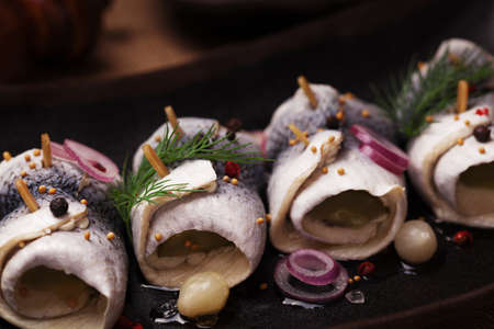 Rolled herring in vinegar, served with onions and pickles. Perfect for vodka.の写真素材