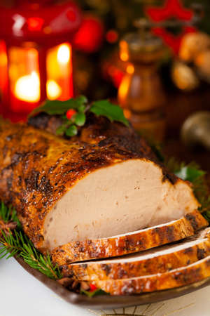 Roast pork loin with Christmas decoration. Front view.の写真素材