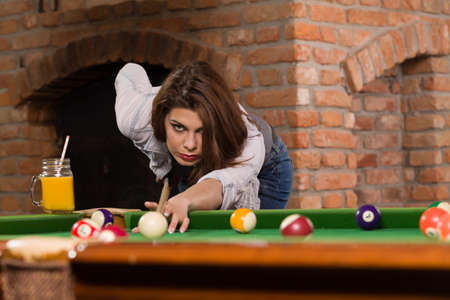 Woman playing billiards