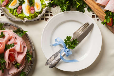 Easter table setting with egg and ham. Top view.