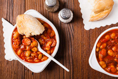 Baked beans in tomato sauce served in plastic cups. Top view.の写真素材