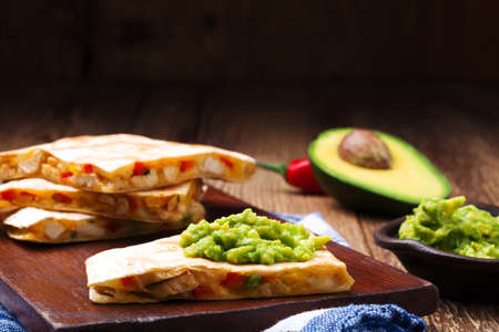 Quesadilla with chicken, served with guacamole or salsa sauce.の写真素材