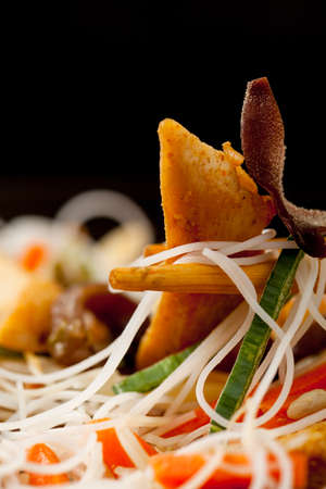 Rice noodles with chicken, mushrooms mun and vegetables, prepared for wook. Close up.の写真素材
