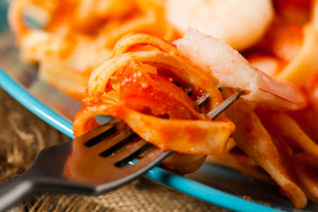 Pasta with shrimps. Wooden background. Front view. Close-up.の写真素材