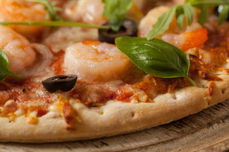 Pizza with shrimps. Front view. Wooden board background. Close-up.の写真素材