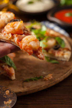 Pizza with shrimps. Front view. Wooden board background. Close-up.の写真素材