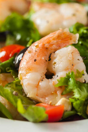 Shrimp salad with tomato, olives and cashew nuts. Front view. Close-up.の写真素材