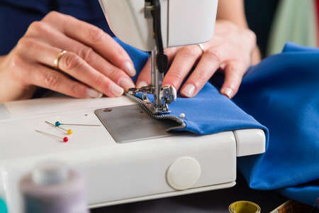 Sewing workshop. Sewing zipper on sewing machine.の写真素材