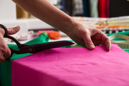 Sewing workshop. Preparing the sewing blanket. Cutting out material. Seam cut cut pattern to sew.の写真素材