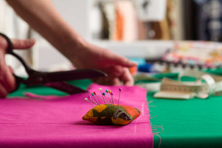 Sewing workshop. Preparing the sewing blanket. Cutting out material. Seam cut cut pattern to sew.の写真素材