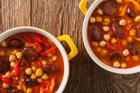 Traditional chickpea soup with paprika and chorizo sausage. Top view.の写真素材