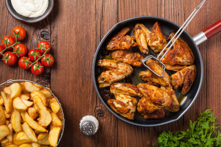 Baked wings, served with dip or baked potatoes. Top view.の写真素材