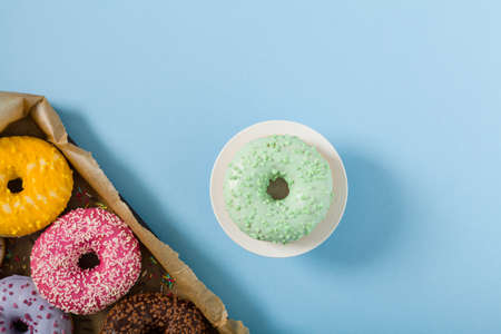 Colorful donuts on a blue background. Top viewの写真素材
