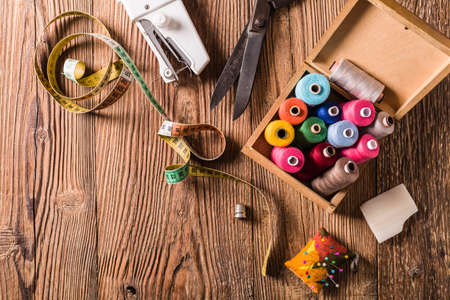 Tailor accessories concept. Natural wooden background. View from above.の写真素材