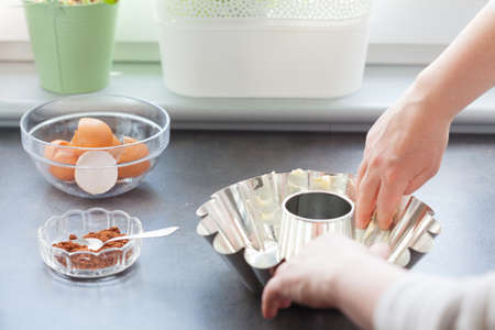 Baking cake. Next stage, preparation of baking mold by greasing with fat and sprinkle with breadcrumbs.の写真素材