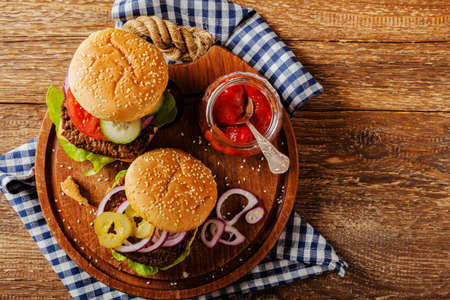 Homemade, beef hamburger with cheese and vegetables. Top view.