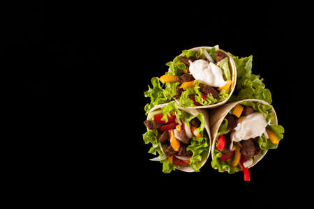 Tortilla with beef. Top view. Black background.の写真素材