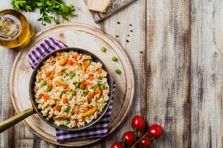 Delicious risotto with chicken and green peas. Top view.の写真素材