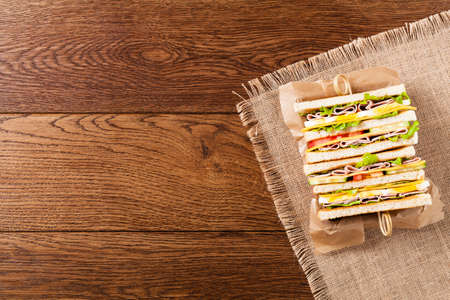 Delicious toast sandwich with ham, cheese, egg and vegetables. Top view.の写真素材