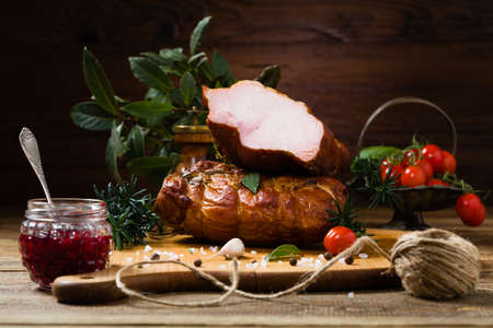 Smoked pork on wooden board. Different types of meat.の写真素材