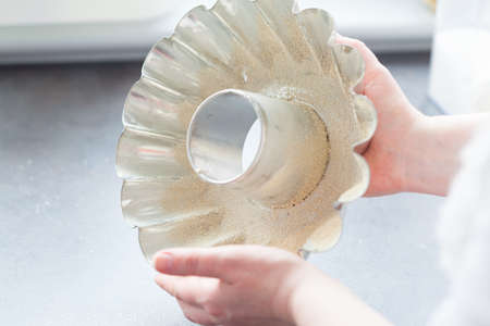 Baking cake. Next stages, following stages. Preparation of baking mold. We grease with fat and sprinkle with breadcrumbs.の写真素材