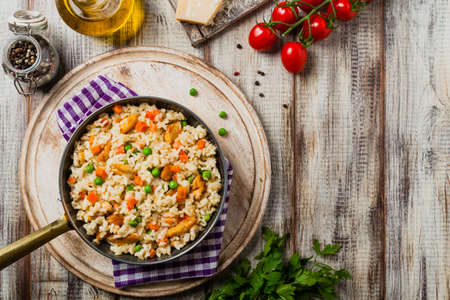Delicious risotto with chicken and green peas. Top view.の写真素材