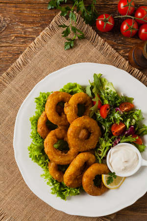 Roasted squid rings with salad. Top view.の写真素材