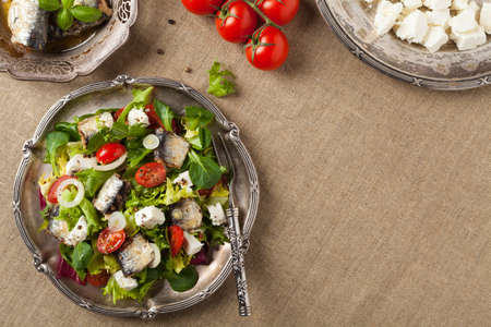 A delicious salad with sardines and feta cheese. Top view.の写真素材