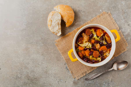 Traditional portuguese goulash with cabbage, beans and ribs. Top view. Stone background.の写真素材