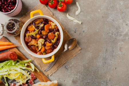 Traditional portuguese goulash with cabbage, beans and ribs. Top view. Stone background.の写真素材