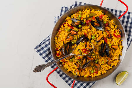 Traditional paella with mussels. Top view. Stone white background.の写真素材