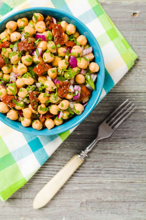 Chickpeas salad with onion and dried tomatoes. Top view.の写真素材