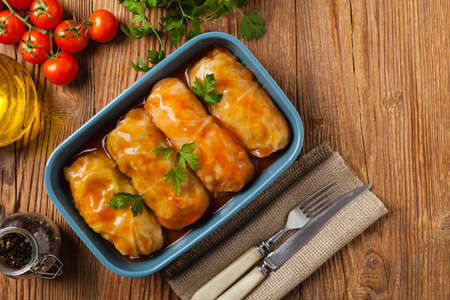 Traditional stuffed cabbage with minced meat and rice, served in a tomato sauce. Top view. Flat lay.