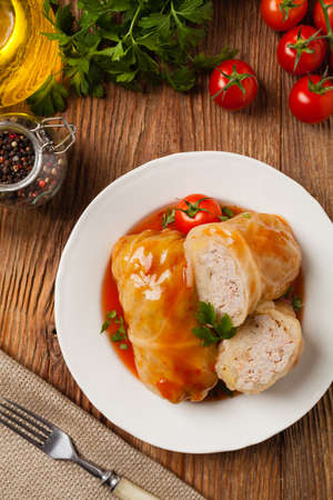 Traditional stuffed cabbage with minced meat and rice, served in a tomato sauce. Top view. Flat lay.の写真素材