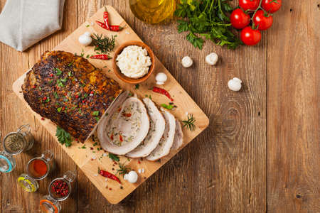 Baked whole bacon. Roulade with minced meat, mushrooms and paprika. Top view.の写真素材