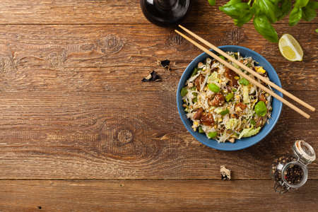 Fried veal, with rice, Chinese cabbage and mushrooms. Sprinkled with sesame and soy sauce. Top view.